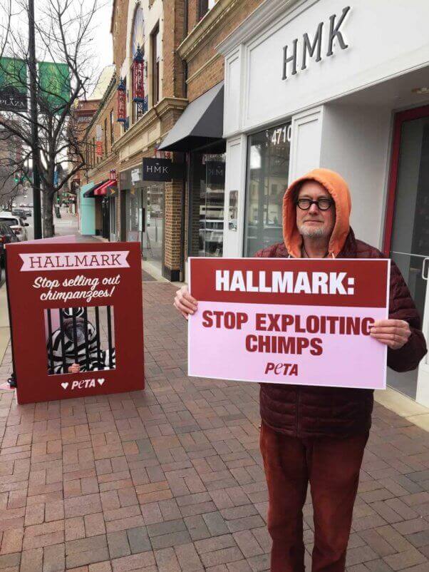 two protesters asking Hallmark to stop selling photos of exploited chimpanzees